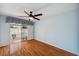Bedroom with wood flooring, ceiling fan, and balcony access at 6400 46Th N Ave # 61, Kenneth City, FL 33709