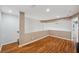 Hallway with wood-look flooring and neutral paint offers easy access to different rooms at 6400 46Th N Ave # 61, Kenneth City, FL 33709
