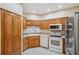 The kitchen boasts oak cabinetry, stainless steel appliances, and a corner sink for efficient meal prep at 6400 46Th N Ave # 61, Kenneth City, FL 33709