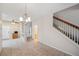 Bright living area with tile flooring, stair access to the upper level, and natural lighting at 6400 46Th N Ave # 61, Kenneth City, FL 33709