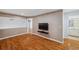Upstairs living room with wood-look flooring, TV and ensuite bathroom access at 6400 46Th N Ave # 61, Kenneth City, FL 33709