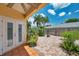 Charming outdoor patio with a tile floor, lush landscaping, and privacy fence at 6400 46Th N Ave # 61, Kenneth City, FL 33709