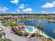 High angle aerial showing a pool, lakefront, well maintained landscaping and manicured bushes in the community at 6400 46Th N Ave # 61, Kenneth City, FL 33709