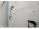 Shower featuring white tiled walls, a shower head, and a glass door at 6400 46Th N Ave # 61, Kenneth City, FL 33709