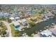 Aerial view of multiple homes on waterways, featuring boats docked outside and views of the open water at 6543 Louise Ct, Hudson, FL 34667