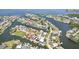 Aerial view of a waterfront community, featuring private docks, beautiful waterways, and canal-front homes at 6543 Louise Ct, Hudson, FL 34667