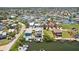Residential homes with docks and boats on waterfront canal in aerial view, providing serene water access at 6543 Louise Ct, Hudson, FL 34667