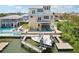 Waterfront property with boat dock and lift, patio, outdoor furniture and easy access to the Gulf at 6543 Louise Ct, Hudson, FL 34667