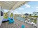 Balcony overlooking the canal with a beautiful view, blue chairs, and chaise lounge at 6543 Louise Ct, Hudson, FL 34667