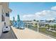 Balcony with glass railing and views of the canal, houses, and lush landscaping at 6543 Louise Ct, Hudson, FL 34667