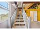 Basement stairs lead to the first floor, next to the downstairs bathroom with a window view of the water at 6543 Louise Ct, Hudson, FL 34667