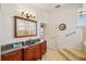 Bright bathroom featuring a vanity with a granite countertop and a walk-in tub with handrails at 6543 Louise Ct, Hudson, FL 34667