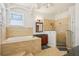 Luxurious bathroom featuring a soaking tub, granite countertop vanity, and walk-in shower at 6543 Louise Ct, Hudson, FL 34667