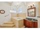 Bathroom with a soaking tub, vanity with granite countertop, and modern fixtures at 6543 Louise Ct, Hudson, FL 34667
