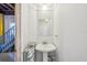 Downstairs bathroom with a pedestal sink, mirror, and towel rack is conveniently located in the basement at 6543 Louise Ct, Hudson, FL 34667