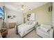 Stylish bedroom with a comfortable chair, dresser, and coastal themed art and decorations at 6543 Louise Ct, Hudson, FL 34667