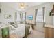 Bright bedroom featuring a ceiling fan, mounted TV, and neutral decor and plenty of natural light at 6543 Louise Ct, Hudson, FL 34667