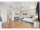 Spacious bedroom featuring a ceiling fan, and a decorative rug enhancing the hardwood flooring at 6543 Louise Ct, Hudson, FL 34667