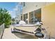 Boat with trailer parked in the drive next to a spiral staircase and screened in outdoor space at 6543 Louise Ct, Hudson, FL 34667