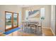 Bright dining area featuring a modern table set, adjacent to French doors leading to an outdoor balcony at 6543 Louise Ct, Hudson, FL 34667