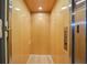 An interior shot of the building elevator with paneled walls, buttons and stainless steel doors at 6543 Louise Ct, Hudson, FL 34667
