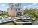 Waterfront home showcasing private boat dock, outdoor patio, and screened-in seating area at 6543 Louise Ct, Hudson, FL 34667