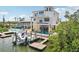 Lovely waterfront home with boat dock, wrap-around terraces and outdoor seating, perfect for entertaining at 6543 Louise Ct, Hudson, FL 34667