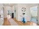 Hallway with hardwood floors, a decorative mirror, and access to a bathroom and living area at 6543 Louise Ct, Hudson, FL 34667