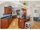 Well-equipped kitchen boasting cherry cabinets, stainless appliances, a sleek island, and convenient dining access at 6543 Louise Ct, Hudson, FL 34667