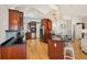 Stylish kitchen featuring cherry cabinets, stainless appliances, sleek countertops, and an inviting open layout at 6543 Louise Ct, Hudson, FL 34667
