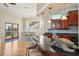 Kitchen with black countertops, barstool seating, access to dining area, and hardwood floors at 6543 Louise Ct, Hudson, FL 34667