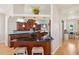 Well-equipped kitchen with dark wood cabinets, black countertops, and breakfast bar with two stools at 6543 Louise Ct, Hudson, FL 34667