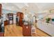 Open kitchen with cherry cabinets, black countertops, stainless steel appliances, and direct access to the living area at 6543 Louise Ct, Hudson, FL 34667