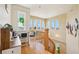 Landing area with charming desk and chair with a chandelier and arched windows that provide abundant natural light at 6543 Louise Ct, Hudson, FL 34667