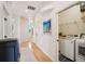 Hallway view into laundry room with modern washer and dryer units at 6543 Louise Ct, Hudson, FL 34667