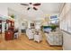 Bright living room featuring hardwood floors, stylish furnishings, and an open layout with kitchen access at 6543 Louise Ct, Hudson, FL 34667