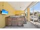 Enclosed patio with a large hot tub and a view of the canal and outdoor boat dock at 6543 Louise Ct, Hudson, FL 34667