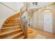 Curved wood staircase with detailed wood flooring, leading to an open hallway with a unique archway entrance at 6543 Louise Ct, Hudson, FL 34667