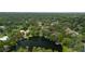 Aerial view shows the property near a large lake surrounded by mature trees and residential areas at 6921 N 16Th St, Tampa, FL 33610