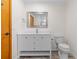 Updated bathroom with white vanity, large mirror, and tiled floors offers a fresh, clean design at 6921 N 16Th St, Tampa, FL 33610
