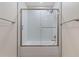 Bathroom featuring bathtub shower combination, shower head and a glass enclosure at 6921 N 16Th St, Tampa, FL 33610