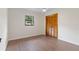 This bedroom features wood floors, a ceiling fan and a large double closet at 6921 N 16Th St, Tampa, FL 33610