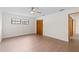 This bedroom features wood floors, a ceiling fan, closet and two windows at 6921 N 16Th St, Tampa, FL 33610