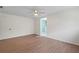 Light-filled bedroom features wood-look flooring and an ensuite bathroom at 6921 N 16Th St, Tampa, FL 33610