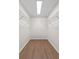 Bright walk-in closet featuring wire shelving, wood-look floors and recessed lighting at 6921 N 16Th St, Tampa, FL 33610