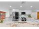 Bright kitchen with white cabinetry, stainless steel appliances, and marble countertops at 6921 N 16Th St, Tampa, FL 33610