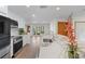 Well-lit kitchen with stainless steel appliances, and a breakfast bar overlooking the living area at 6921 N 16Th St, Tampa, FL 33610