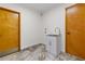 Laundry room with white cabinets, stainless steel sink, and tile flooring at 6921 N 16Th St, Tampa, FL 33610