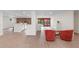 Open-concept living room with hardwood floors, recessed lighting, and brick accent wall at 6921 N 16Th St, Tampa, FL 33610