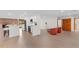Open-concept living space featuring wood floors, a brick fireplace, and modern kitchen with stainless steel appliances at 6921 N 16Th St, Tampa, FL 33610